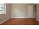 This bedroom provides a well-lit space with a large window and stylish wood flooring at 1828 Foxhunt Dr # A, Sun City Center, FL 33573