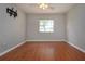 Bedroom featuring hardwood floors, one window, and ceiling fan at 1828 Foxhunt Dr # A, Sun City Center, FL 33573
