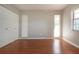 Bedroom featuring hardwood floors, 2 windows, and a double door closet at 1828 Foxhunt Dr # A, Sun City Center, FL 33573