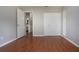 This bedroom features wood floors, a double door closet, and an attached bathroom for convenience at 1828 Foxhunt Dr # A, Sun City Center, FL 33573