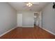 Bedroom featuring hardwood floors, a closet, ceiling fan and open bathroom at 1828 Foxhunt Dr # A, Sun City Center, FL 33573