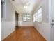 Bright dining area with wood floors, chair rail, and two large windows at 1828 Foxhunt Dr # A, Sun City Center, FL 33573
