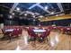 Expansive event space with round tables, chairs, stage, and ample lighting at 1828 Foxhunt Dr # A, Sun City Center, FL 33573