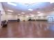 Open dance and fitness space features a smooth wood floor and a full wall mirror, perfect for activities at 1828 Foxhunt Dr # A, Sun City Center, FL 33573
