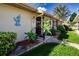 Inviting front entrance with garden and art accents and well-manicured lawn at 1828 Foxhunt Dr # A, Sun City Center, FL 33573