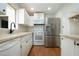 Well-equipped kitchen with white cabinets, stainless steel appliances, and bright natural light at 1828 Foxhunt Dr # A, Sun City Center, FL 33573