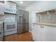 Modern kitchen with stainless steel appliances, lots of counter space, and wood-look floors at 1828 Foxhunt Dr # A, Sun City Center, FL 33573
