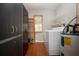 Functional laundry room with built-in storage cabinets and shelving at 1828 Foxhunt Dr # A, Sun City Center, FL 33573