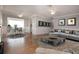 Open-concept living and dining room with neutral tones, wood flooring, and modern furniture at 1828 Foxhunt Dr # A, Sun City Center, FL 33573