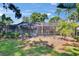 Back of the home featuring a screened-in pool area, providing a relaxing and private outdoor space at 1905 Horseshoe Dr, Plant City, FL 33566