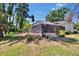 A backyard boasts a screened pool and lanai, creating an outdoor retreat in a lush, green setting at 1905 Horseshoe Dr, Plant City, FL 33566