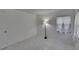Bedroom features a floor lamp, window and bright, natural light with tile floors at 1905 Horseshoe Dr, Plant City, FL 33566