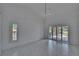 Bright bedroom features tile floors, window with shutters, and sliding doors to the outdoor patio at 1905 Horseshoe Dr, Plant City, FL 33566