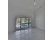 Bright bedroom featuring tile flooring, ceiling fan, and sliding glass doors to the pool at 1905 Horseshoe Dr, Plant City, FL 33566