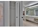 Walk-in closet with shelves and view into bathroom with shower at 1905 Horseshoe Dr, Plant City, FL 33566