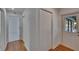 Hallway view with hardwood floor, a closet and an open doorway at 1905 Horseshoe Dr, Plant City, FL 33566