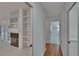 Hallway view with white tile floor, shelving and an open doorway at 1905 Horseshoe Dr, Plant City, FL 33566