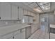 Bright kitchen features white cabinetry, tile floors, and stainless steel appliances at 1905 Horseshoe Dr, Plant City, FL 33566