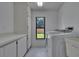 Bright laundry room with window, modern washer/dryer and storage space at 1905 Horseshoe Dr, Plant City, FL 33566