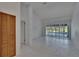 Bright, open living room featuring vaulted ceilings, tile floors, and sliding doors overlooking the pool at 1905 Horseshoe Dr, Plant City, FL 33566