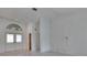 Bright living room with vaulted ceilings, a double-door entryway, and neutral colors at 1905 Horseshoe Dr, Plant City, FL 33566