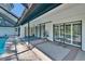 Covered patio with ceiling fan, area rugs, and access to the pool area at 1905 Horseshoe Dr, Plant City, FL 33566