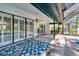 This covered patio has sliding glass doors, fan, and is accessible to the pool at 1905 Horseshoe Dr, Plant City, FL 33566