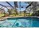 A sun-drenched pool surrounded by a screened enclosure and lush greenery, providing a private oasis at 1905 Horseshoe Dr, Plant City, FL 33566