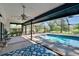 Enclosed pool area with blue patterned rug and ceiling fan offering an indoor/outdoor experience at 1905 Horseshoe Dr, Plant City, FL 33566
