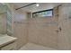 Tiled stand up shower with a window at 1905 Horseshoe Dr, Plant City, FL 33566