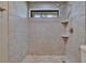 Beautifully tiled bathroom with tiled shower and shelving at 1905 Horseshoe Dr, Plant City, FL 33566