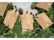 Aerial view of waterfront homes featuring tile roofs, lush landscaping, and circular driveways at 191 Banyan Bay Dr, St Petersburg, FL 33705