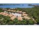Stunning aerial view of waterfront homes surrounded by lush greenery with boat docks and scenic water views at 191 Banyan Bay Dr, St Petersburg, FL 33705