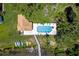 Aerial view of the pool, patio and waterfront with a collection of kayaks and paddle boards at 191 Banyan Bay Dr, St Petersburg, FL 33705