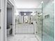 Bright bathroom featuring a double vanity, marble floors, and a glass enclosed shower at 191 Banyan Bay Dr, St Petersburg, FL 33705