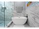 This bathroom features a modern soaking tub, marble tile and mosaic accents at 191 Banyan Bay Dr, St Petersburg, FL 33705