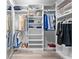 Spacious walk-in closet with custom shelving and ample storage space for clothes and accessories at 191 Banyan Bay Dr, St Petersburg, FL 33705