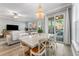 Elegant dining room featuring a marble table, chandelier, and sliding glass doors to the outdoor patio at 191 Banyan Bay Dr, St Petersburg, FL 33705