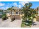 Beautiful two-story house featuring a balcony, three-car garage, and patterned-brick driveway at 191 Banyan Bay Dr, St Petersburg, FL 33705