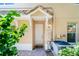 Inviting front entrance with a covered porch, well-kept plants, and brick walkway at 191 Banyan Bay Dr, St Petersburg, FL 33705