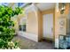 Welcoming front entrance featuring a white door, lush plants, and a well-maintained brick walkway at 191 Banyan Bay Dr, St Petersburg, FL 33705