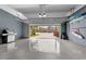 Spacious two-car garage with a modern epoxy floor and ample storage, great for organization at 191 Banyan Bay Dr, St Petersburg, FL 33705