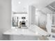 Modern kitchen featuring white cabinets, stainless steel appliances, and a breakfast bar at 191 Banyan Bay Dr, St Petersburg, FL 33705