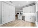 Modern kitchen with white cabinetry, stainless steel appliances, and stone countertops at 191 Banyan Bay Dr, St Petersburg, FL 33705