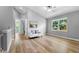 Bright loft area featuring hardwood floors, and comfortable seating with backyard views through a window at 191 Banyan Bay Dr, St Petersburg, FL 33705