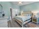 Bright bedroom with light blue walls, light wood floors, and ample natural light at 191 Banyan Bay Dr, St Petersburg, FL 33705