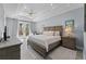 Bright main bedroom featuring a tray ceiling, hardwood floors, and balcony access for a luxurious feel at 191 Banyan Bay Dr, St Petersburg, FL 33705