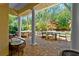 Inviting covered outdoor patio with comfortable seating and lush landscaping at 191 Banyan Bay Dr, St Petersburg, FL 33705