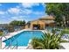 Inviting pool area surrounded by comfortable seating, lush greenery, and blue skies at 191 Banyan Bay Dr, St Petersburg, FL 33705