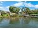 Scenic waterfront view with dock, charming buildings, and lush landscaping, creating a serene coastal living environment at 191 Banyan Bay Dr, St Petersburg, FL 33705
